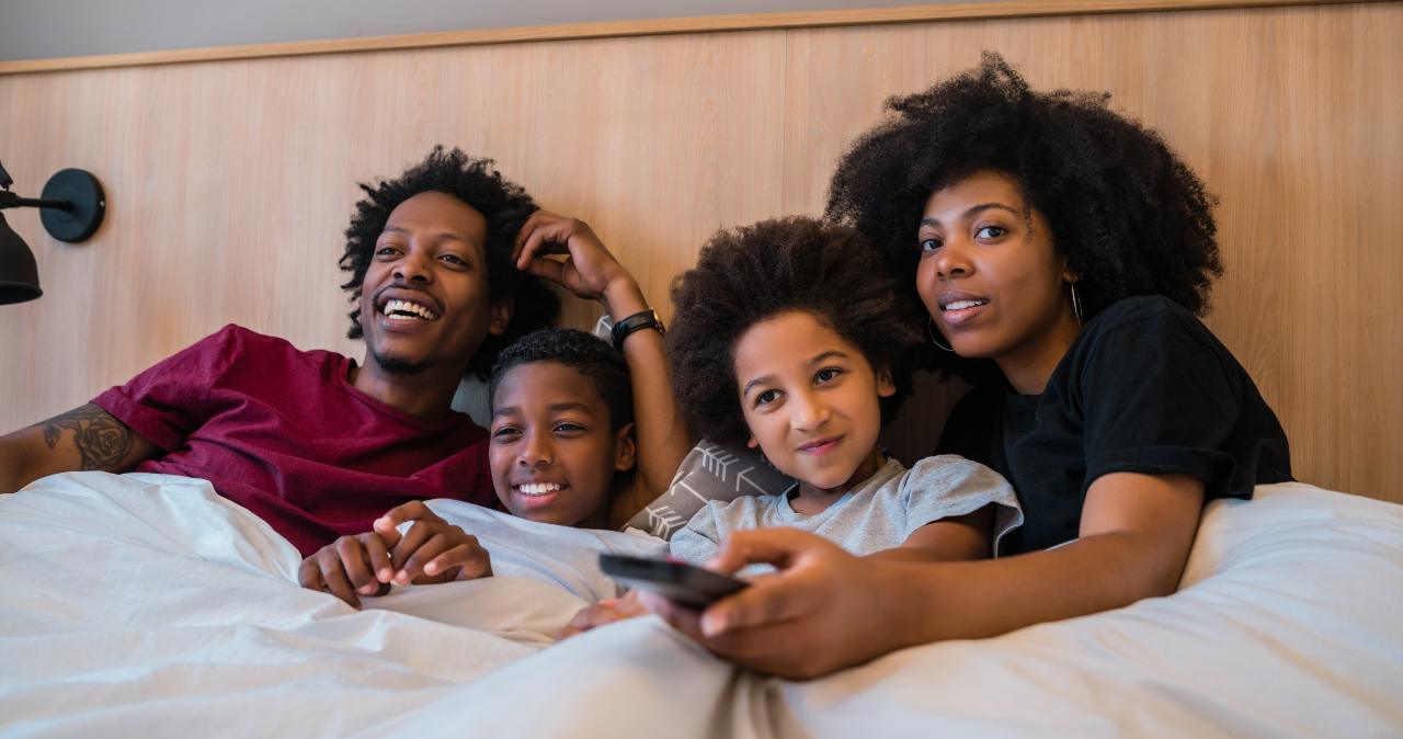 Familia de cuatro miembros ve la tele desde la cama el 6 de abril