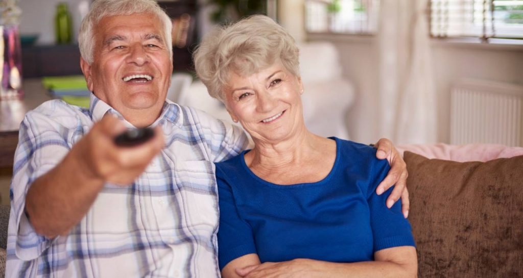 Pareja de personas mayores ve la televisión el 19 de junio